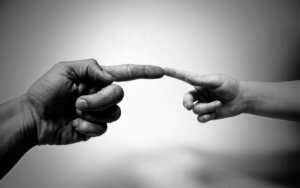 aba therapist and child touch fingers