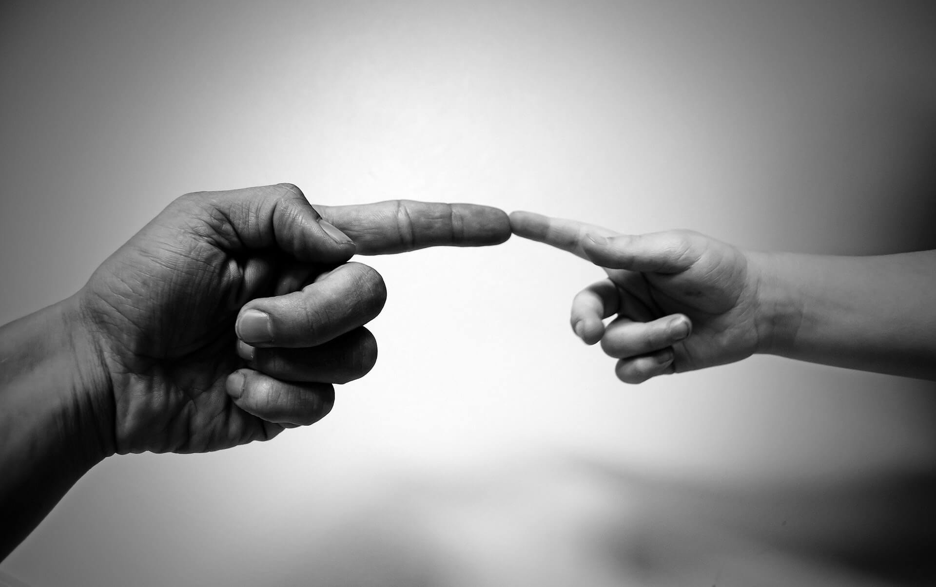 aba therapist and child touch fingers