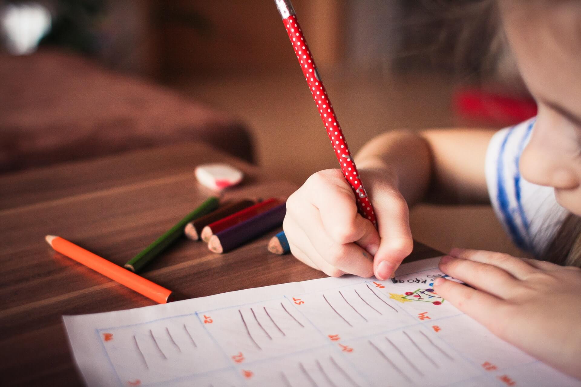 child writes at in-home early intervention services