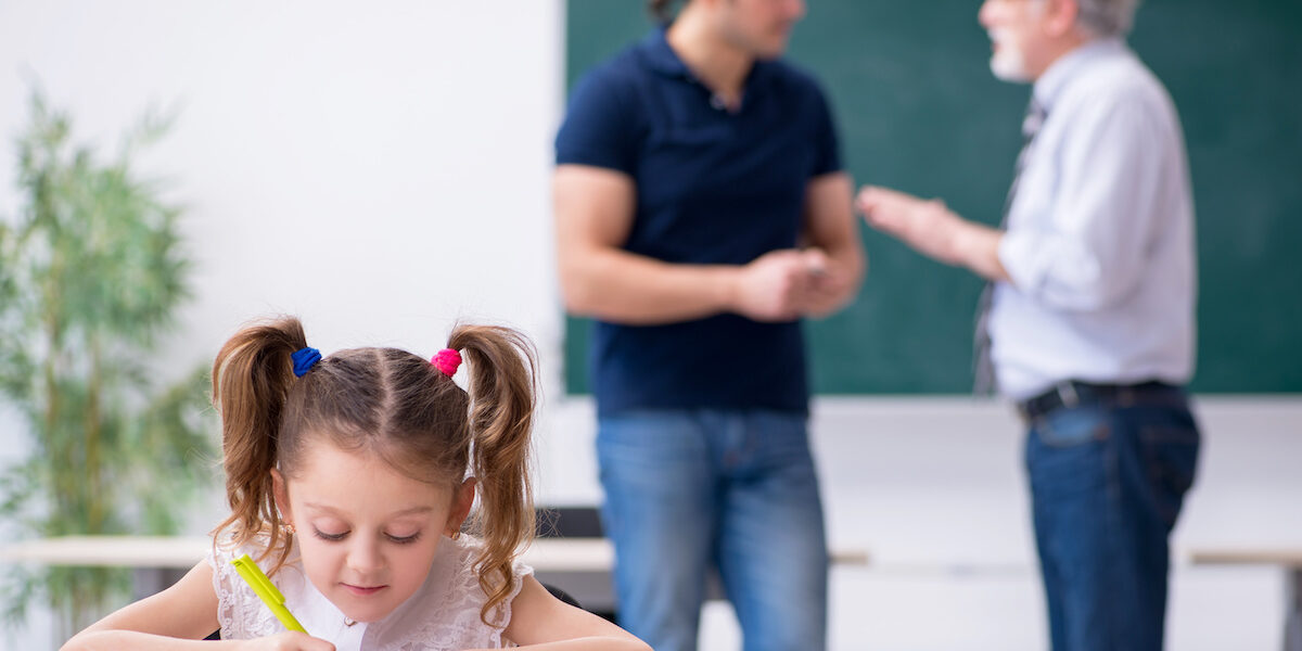 Young parent, old male teacher and little girl in the classroom Navigating the IEP Process for Children on the Autism Spectrum