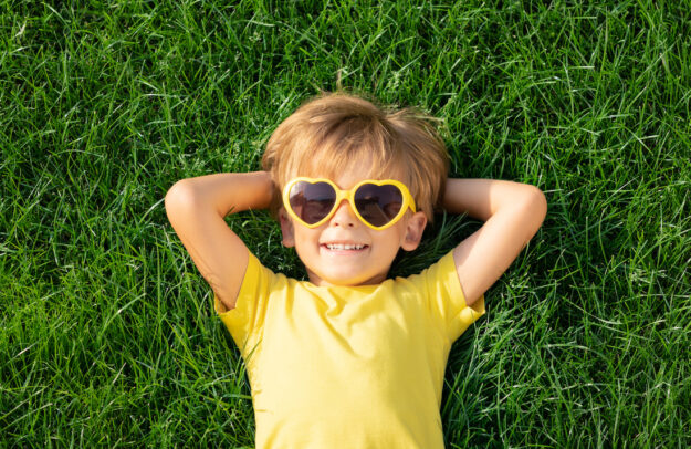 Happy child playing outdoor in spring park